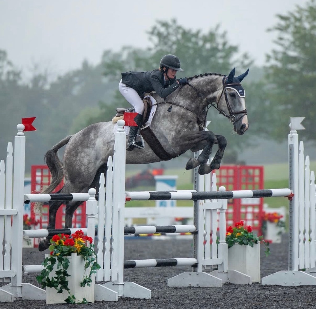 Sterling Pollard & Tinto soaring over show jump fence